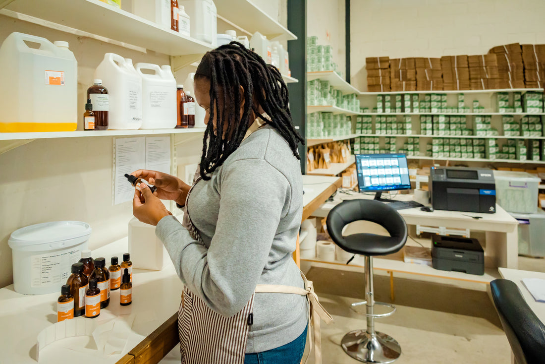 Essentially Natural team member labelling a product behind the scenes